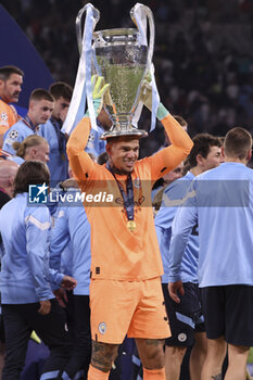 2023-06-10 - Manchester City goalkeeper Ederson Moraes celebrates during the trophy ceremony following the UEFA Champions League, Final football match between Manchester City FC and FC Internazionale (Inter Milan) on June 10, 2023 at Ataturk Olympic Stadium in Istanbul, Turkey - FOOTBALL - CHAMPIONS LEAGUE - FINAL - MANCHESTER CITY V INTERNAZIONALE - UEFA CHAMPIONS LEAGUE - SOCCER