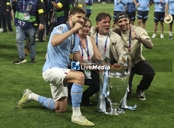 2023-06-10 - Ruben Dias of Manchester City celebrates with the trophy following the UEFA Champions League, Final football match between Manchester City FC and FC Internazionale (Inter Milan) on June 10, 2023 at Ataturk Olympic Stadium in Istanbul, Turkey - FOOTBALL - CHAMPIONS LEAGUE - FINAL - MANCHESTER CITY V INTERNAZIONALE - UEFA CHAMPIONS LEAGUE - SOCCER