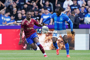 2023-08-02 - Dereck Kutesa of Servette FC battles for possession with Joseph Paintsil of KRC Genk during the UEFA Champions League, Second qualifying round, 2nd leg football match between KRC Genk and Servette FC on August 2, 2023 at the Cegeka Arena in Genk, Belgium - FOOTBALL - CHAMPIONS LEAGUE - KRC GENK V SERVETTE FC - UEFA CHAMPIONS LEAGUE - SOCCER