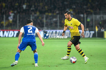 2023-08-19 - 28 Ehsan Haji Safi of AEK FC competing with 2 Sadegh Moharrami of GNK Dinamo Zagreb during the UEFA Champions League, 3rd Qualification Round match between AEK FC and GNK Dinamo Zagreb at Opap Arena on August 19, 2023, in Athens, Greece. - AEK-DINAMO ZAGREB 3RD QUALIFICATION ROUND - UEFA CHAMPIONS LEAGUE - SOCCER