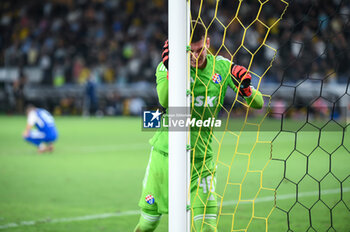 2023-08-19 - 40 Dominik Livakovic of GNK Dinamo Zagreb disappointed after a goal conceded during the UEFA Champions League, 3rd Qualification Round match between AEK FC and GNK Dinamo Zagreb at Opap Arena on August 19, 2023, in Athens, Greece. - AEK-DINAMO ZAGREB 3RD QUALIFICATION ROUND - UEFA CHAMPIONS LEAGUE - SOCCER