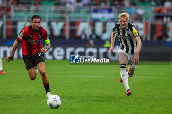 2023-09-19 - Anthony Gordon of Newcastle United FC competes for the ball with Davide Calabria of AC Milan during UEFA Champions League 2023/24 Group Stage - Group F football match between AC Milan and Newcastle United FC at San Siro Stadium, Milan, Italy on September 19, 2023 - AC MILAN VS NEWCASTLE UNITED FC - UEFA CHAMPIONS LEAGUE - SOCCER