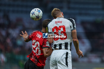 2023-09-19 - Dan Burn of Newcastle United FC competes for the ball with Malick Thiaw of AC Milan during UEFA Champions League 2023/24 Group Stage - Group F football match between AC Milan and Newcastle United FC at San Siro Stadium, Milan, Italy on September 19, 2023 - AC MILAN VS NEWCASTLE UNITED FC - UEFA CHAMPIONS LEAGUE - SOCCER