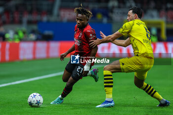 2023-11-28 - Samuel Chukwueze of AC Milan competes for the ball with Ramy Bensebaini of Borussia Dortmund during UEFA Champions League 2023/24 Group Stage - Group F football match between AC Milan and Borussia Dortmund at San Siro Stadium, Milan, Italy on November 28, 2023 - AC MILAN VS BORUSSIA DORTMUND - UEFA CHAMPIONS LEAGUE - SOCCER