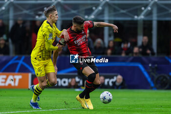 2023-11-28 - Olivier Giroud of AC Milan competes for the ball with Nico Schlotterbeck of Borussia Dortmund during UEFA Champions League 2023/24 Group Stage - Group F football match between AC Milan and Borussia Dortmund at San Siro Stadium, Milan, Italy on November 28, 2023 - AC MILAN VS BORUSSIA DORTMUND - UEFA CHAMPIONS LEAGUE - SOCCER