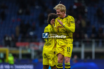2023-11-28 - Julian Brandt of Borussia Dortmund celebrates the victory at the end of the match with Karim Adeyemi of Borussia Dortmund during UEFA Champions League 2023/24 Group Stage - Group F football match between AC Milan and Borussia Dortmund at San Siro Stadium, Milan, Italy on November 28, 2023 - AC MILAN VS BORUSSIA DORTMUND - UEFA CHAMPIONS LEAGUE - SOCCER