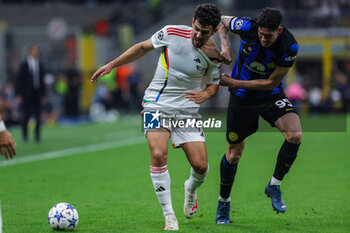 2023-10-03 - Tomas Araujo of SL Benfica competes for the ball with Alessandro Bastoni of FC Internazionale during the UEFA Champions League 2023/24 Group Stage - Group D football match between FC Internazionale and SL Benfica at Giuseppe Meazza Stadium, Milan, Italy on October 03, 2023 - INTER - FC INTERNAZIONALE VS SL BENFICA - UEFA CHAMPIONS LEAGUE - SOCCER