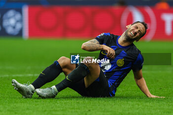 2023-10-03 - Hakan Calhanoglu of FC Internazionale injured during the UEFA Champions League 2023/24 Group Stage - Group D football match between FC Internazionale and SL Benfica at Giuseppe Meazza Stadium, Milan, Italy on October 03, 2023 - INTER - FC INTERNAZIONALE VS SL BENFICA - UEFA CHAMPIONS LEAGUE - SOCCER