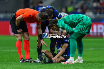 2023-10-03 - Hakan Calhanoglu of FC Internazionale injured during the UEFA Champions League 2023/24 Group Stage - Group D football match between FC Internazionale and SL Benfica at Giuseppe Meazza Stadium, Milan, Italy on October 03, 2023 - INTER - FC INTERNAZIONALE VS SL BENFICA - UEFA CHAMPIONS LEAGUE - SOCCER