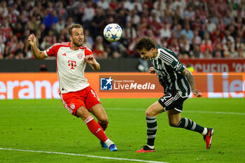 2023-09-20 - Victor Lindelof (2) of Manchester United heads clear from Harry Kane (9) of Bayern Munich during the Champions League match between Bayern Munich and Manchester United at Allianz Arena, Munich, Germany on 20 September 2023. Photo Nigel Keene/ProSportsImages / DPPI - FOOTBALL - CHAMPIONS LEAGUE - BAYERN MUNICH V MANCHESTER UNITED - UEFA CHAMPIONS LEAGUE - SOCCER