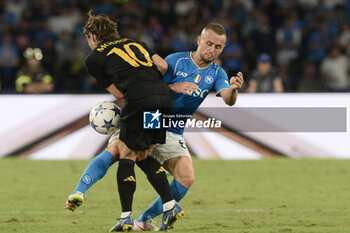 2023-10-03 - Luka Modric of Real Madrid FC competes for the ball with Stanislav Lobotka of SSC Napoli during the Uefa Champions League between SSC Napoli vs Real Madrid FC at Diego Armando Maradona Stadium - SSC NAPOLI VS REAL MADRID FC - UEFA CHAMPIONS LEAGUE - SOCCER