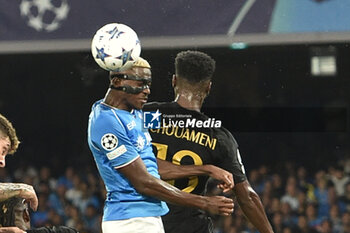 2023-10-03 - Victor Osimen of SSC Napoli competes for the ball with Aurelien Tchouameni of Real Madrid FC during the Uefa Champions League between SSC Napoli vs Real Madrid FC at Diego Armando Maradona Stadium - SSC NAPOLI VS REAL MADRID FC - UEFA CHAMPIONS LEAGUE - SOCCER