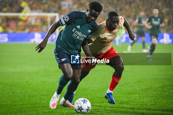2023-10-03 - Bukayo SAKA of Arsenal and Deiver MACHADO of Lens during the UEFA Champions League, Group B football match between RC Lens and Arsenal FC on October 3, 2023 at Bollaert-Delelis stadium in Lens, France - FOOTBALL - CHAMPIONS LEAGUE - LENS V ARSENAL - UEFA CHAMPIONS LEAGUE - SOCCER