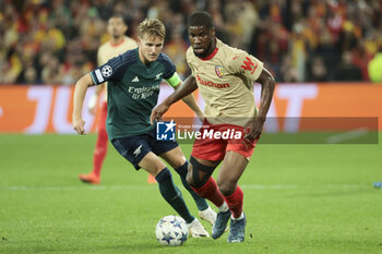 2023-10-03 - Kevin Danso of Lens, left Martin Odegaard of Arsenal during the UEFA Champions League, Group B football match between RC Lens and Arsenal FC on October 3, 2023 at Bollaert-Delelis stadium in Lens, France - FOOTBALL - CHAMPIONS LEAGUE - LENS V ARSENAL - UEFA CHAMPIONS LEAGUE - SOCCER