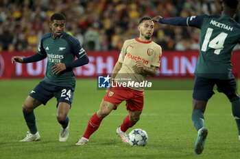 2023-10-03 - Ruben Aguilar of Lens, left Reiss Nelson of Arsenal during the UEFA Champions League, Group B football match between RC Lens and Arsenal FC on October 3, 2023 at Bollaert-Delelis stadium in Lens, France - FOOTBALL - CHAMPIONS LEAGUE - LENS V ARSENAL - UEFA CHAMPIONS LEAGUE - SOCCER