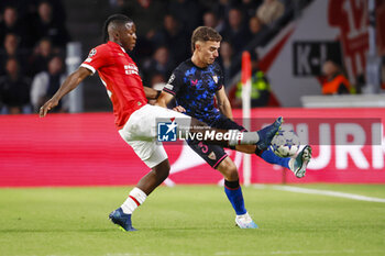 2023-10-03 - Johan Bakayoko of PSV battles for possession with Adria Pedrosa of Sevilla FC during the UEFA Champions League, Group B football match between PSV Eindhoven and Sevilla FC on October 3, 2023 at the Phillips Stadion in Eindhoven, Netherlands - FOOTBALL - CHAMPIONS LEAGUE - PSV EINDHOVEN V SEVILLA - UEFA CHAMPIONS LEAGUE - SOCCER