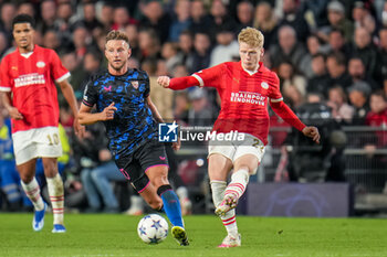 2023-10-03 - Jerdy Schouten of PSV and Ivan Rakitic of Sevilla FC during the UEFA Champions League, Group B football match between PSV Eindhoven and Sevilla FC on October 3, 2023 at the Phillips Stadion in Eindhoven, Netherlands - FOOTBALL - CHAMPIONS LEAGUE - PSV EINDHOVEN V SEVILLA - UEFA CHAMPIONS LEAGUE - SOCCER