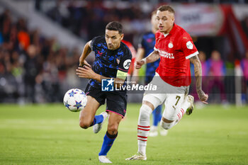 2023-10-03 - Jesus Navas of Sevilla FC battles for possession with Noa Lang of PSV during the UEFA Champions League, Group B football match between PSV Eindhoven and Sevilla FC on October 3, 2023 at the Phillips Stadion in Eindhoven, Netherlands - FOOTBALL - CHAMPIONS LEAGUE - PSV EINDHOVEN V SEVILLA - UEFA CHAMPIONS LEAGUE - SOCCER