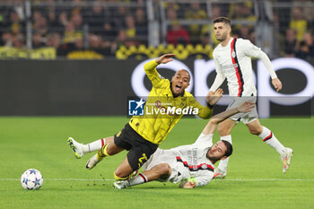 2023-10-04 - Donyell Malen of Borussia Dortmund and Davide Calabria of AC Milan during the UEFA Champions League, Group F football match between Borussia Dortmund and AC Milan on October 4, 2023 at Signal Iduna Park in Dortmund, Germany - FOOTBALL - CHAMPIONS LEAGUE - DORTMUND V MILAN - UEFA CHAMPIONS LEAGUE - SOCCER