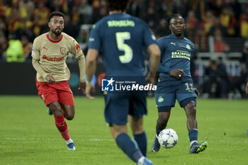 2023-10-24 - Johan Bakayoko of PSV Eindhoven, left Angelo Fulgini of Lens during the UEFA Champions League, Group B football match between RC Lens (RCL) and PSV Eindhoven on October 24, 2023 at Stade Bollaert-Delelis in Lens, France - FOOTBALL - CHAMPIONS LEAGUE - LENS V PSV - UEFA CHAMPIONS LEAGUE - SOCCER