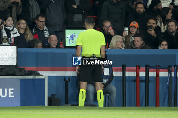 2023-10-25 - Referee Slavko Vincic of Slovenia watching the VAR (video assistance) during the UEFA Champions League, Group F football match between Paris Saint-Germain and AC Milan on October 25, 2023 at Parc des Princes stadium in Paris, France - FOOTBALL - CHAMPIONS LEAGUE - PARIS SG V MILAN - UEFA CHAMPIONS LEAGUE - SOCCER