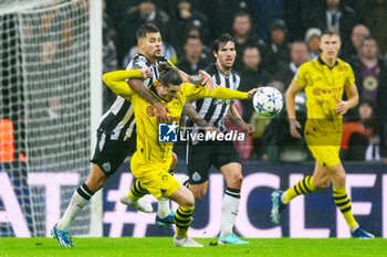 2023-10-25 - Bruno Guimaraes of Newcastle pulls down Marcel Sabitzer of Borussia Dortmund during the UEFA Champions League, Group F football match between Newcastle United and Borussia Dortmund on 25 October 2023 at St. James' Park in Newcastle, England - FOOTBALL - CHAMPIONS LEAGUE - NEWCASTLE V DORTMUND - UEFA CHAMPIONS LEAGUE - SOCCER