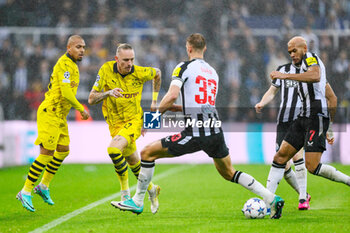 2023-10-25 - Marius Wolf of Borussia Dortmund runs past Dan Burn of Newcastle during the UEFA Champions League, Group F football match between Newcastle United and Borussia Dortmund on 25 October 2023 at St. James' Park in Newcastle, England - FOOTBALL - CHAMPIONS LEAGUE - NEWCASTLE V DORTMUND - UEFA CHAMPIONS LEAGUE - SOCCER