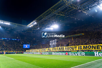 2023-11-07 - Protest with fake money and gold by supporters and fans of Borussia Dortmund, with banner you don’t care about the sport all you care about is money during the UEFA Champions League, Group F football match between Borussia Dortmund and Newcastle United on November 7, 2023 at Signal Iduna Park in Dortmund, Germany - FOOTBALL - CHAMPIONS LEAGUE - DORTMUND V NEWCASTLE - UEFA CHAMPIONS LEAGUE - SOCCER