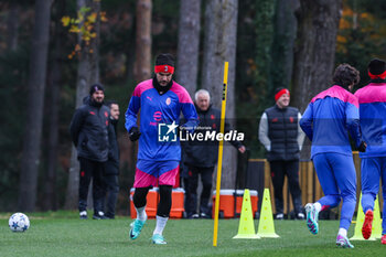 2023-11-27 - Theo Hernandez of AC Milan warms up during the AC Milan training session at Milanello Sports Center ahead of their UEFA Champions League 2023/24 Group Stage F match against Borussia Dortmund at Centro Sportivo Milanello, Carnago, Italy on November 27, 2023 - AC MILAN TRAINING - UEFA CHAMPIONS LEAGUE - SOCCER