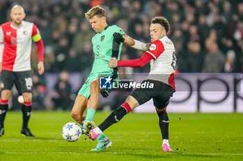 2023-11-28 - Marcos Llorente of Atletico Madrid is challenged by Quilindschy Hartman of Feyenoord during the UEFA Champions League, Group E football match between Feyenoord and Atletico Madrid on November 28, 2023 at Stadion Feijenoord "De Kuip" in Rotterdam, Netherlands - FOOTBALL - CHAMPIONS LEAGUE - FEYENOORD V ATLETICO MADRID - UEFA CHAMPIONS LEAGUE - SOCCER