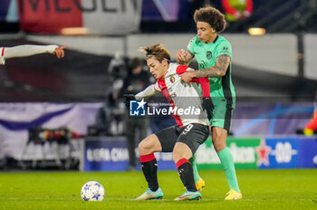 2023-11-28 - Ayase Ueda of Feyenoord is challenged by Axel Witsel of Atletico Madrid during the UEFA Champions League, Group E football match between Feyenoord and Atletico Madrid on November 28, 2023 at Stadion Feijenoord "De Kuip" in Rotterdam, Netherlands - FOOTBALL - CHAMPIONS LEAGUE - FEYENOORD V ATLETICO MADRID - UEFA CHAMPIONS LEAGUE - SOCCER