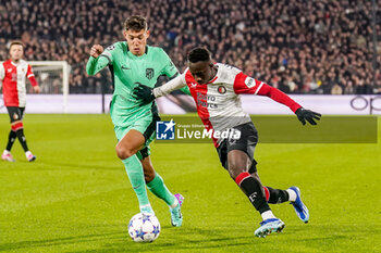2023-11-28 - Yankuba Minteh of Feyenoord is challenged by Nahuel Molina of Atletico Madrid during the UEFA Champions League, Group E football match between Feyenoord and Atletico Madrid on November 28, 2023 at Stadion Feijenoord "De Kuip" in Rotterdam, Netherlands - FOOTBALL - CHAMPIONS LEAGUE - FEYENOORD V ATLETICO MADRID - UEFA CHAMPIONS LEAGUE - SOCCER