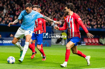 2023-12-13 - Matias Vecino of Lazio seen in action against Saul Niguez and Mario Hermoso of Atletico Madrid during the Champions League football match between Atletico Madrid and Lazio at Metropolitano Stadium in Madrid, Spain. - ATLETICO MADRID VS SS LAZIO - UEFA CHAMPIONS LEAGUE - SOCCER