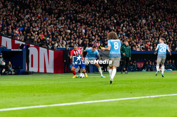 2023-12-13 - Memphis Depay of Atletico Madrid seen in action against Matias Vecino of Lazio during the Champions League football match between Atletico Madrid and Lazio at Metropolitano Stadium in Madrid, Spain. - ATLETICO MADRID VS SS LAZIO - UEFA CHAMPIONS LEAGUE - SOCCER