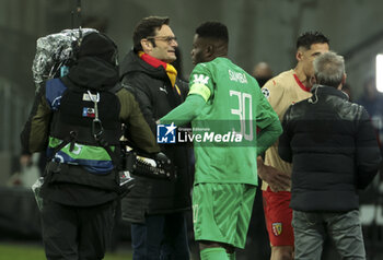 2023-12-12 - Lens goalkeeper Brice Samba celebrates the victory with owner of RC Lens Joseph Oughourlian following the UEFA Champions League, Group B football match between RC Lens and Sevilla FC on December 12, 2023 at Bollaert-Delelis stadium in Lens, France - FOOTBALL - CHAMPIONS LEAGUE - LENS V SEVILLA - UEFA CHAMPIONS LEAGUE - SOCCER