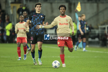 2023-12-12 - Juanlu Sanchez of Sevilla FC, Elye Wahi of Lens during the UEFA Champions League, Group B football match between RC Lens and Sevilla FC on December 12, 2023 at Bollaert-Delelis stadium in Lens, France - FOOTBALL - CHAMPIONS LEAGUE - LENS V SEVILLA - UEFA CHAMPIONS LEAGUE - SOCCER