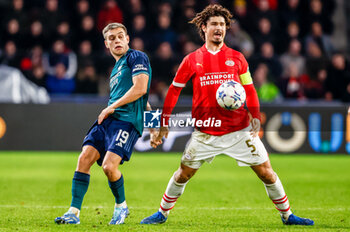 2023-12-12 - Andre Ramalho of PSV is challenged by Leandro Trossard of Arsenal during the UEFA Champions League, Group B football match between PSV and Arsenal on December 12, 2023 at the Phillips Stadion in Eindhoven, Netherlands - FOOTBALL - CHAMPIONS LEAGUE - PSV V ARSENAL - UEFA CHAMPIONS LEAGUE - SOCCER