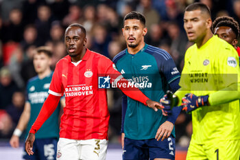 2023-12-12 - Jordan Teze of PSV and William Saliba of Arsenal during the UEFA Champions League, Group B football match between PSV and Arsenal on December 12, 2023 at the Phillips Stadion in Eindhoven, Netherlands - FOOTBALL - CHAMPIONS LEAGUE - PSV V ARSENAL - UEFA CHAMPIONS LEAGUE - SOCCER