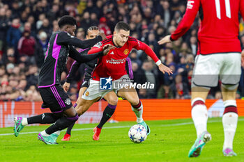 2023-12-13 - Diogo Dalot (20) of Manchester United and Alphonso Davies of Bayern Munich during the UEFA Champions League, Group A football match between Manchester United and Bayern Munich on 12 December 2023 at Old Trafford in Manchester, England - FOOTBALL - CHAMPIONS LEAGUE - MANCHESTER UNITED V BAYERN MUNICH - UEFA CHAMPIONS LEAGUE - SOCCER