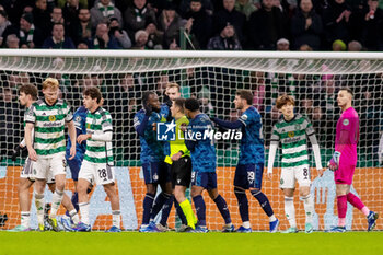 2023-12-13 - Feyenoord players surround the referee after he awards a penalty to Celtic during the UEFA Champions League, Group E football match between Celtic FC and Feyenoord on December 13, 2023 at Celtic Park in Glasgow, Scotland - FOOTBALL - CHAMPIONS LEAGUE - CELTIC V FEYENOORD - UEFA CHAMPIONS LEAGUE - SOCCER