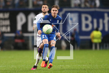 2023-04-13 - Cristiano Biraghi of Fiorentina Michal Skoras of Lech during the UEFA Europa Conference League, Quarter-finals, 1st leg football match between KKS Lech Poznan and ACF Fiorentina on April 13, 2023 at INEA Stadion in Poznan, Poland - FOOTBALL - CONFERENCE LEAGUE - LECH POZNAN V FIORENTINA - UEFA CONFERENCE LEAGUE - SOCCER