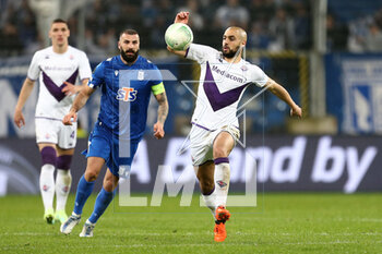 2023-04-13 - Mikael Ishak of Lech Sofyan Amrabat of Fiorentina during the UEFA Europa Conference League, Quarter-finals, 1st leg football match between KKS Lech Poznan and ACF Fiorentina on April 13, 2023 at INEA Stadion in Poznan, Poland - FOOTBALL - CONFERENCE LEAGUE - LECH POZNAN V FIORENTINA - UEFA CONFERENCE LEAGUE - SOCCER