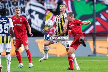 2023-08-31 - Edin Dzeko of Fenerbahce heads the ball with Mathias Kjolo of FC Twente during the UEFA Europa Conference League, Play-offs, 2nd leg football match between FC Twente and Fenerbahce on August 31, 2023 at De Grolsch Veste in Enschede, Netherlands - FOOTBALL - CONFERENCE LEAGUE - TWENTE V FENERBAHCE - UEFA CONFERENCE LEAGUE - SOCCER