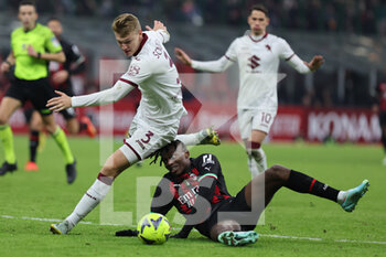 2023-01-11 - Rafael Leao of AC Milan competes for the ball with Perr Schuurs of Torino FC during Coppa Italia 2022/23 football match between AC Milan and Torino FC at San Siro Stadium, Milan, Italy on January 11, 2023 - AC MILAN VS TORINO FC - ITALIAN CUP - SOCCER