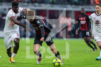 2023-01-11 - Charles De Ketelaere of AC Milan competes for the ball with Ndary Adopo of Torino FC during Coppa Italia 2022/23 football match between AC Milan and Torino FC at San Siro Stadium, Milan, Italy on January 11, 2023 - AC MILAN VS TORINO FC - ITALIAN CUP - SOCCER