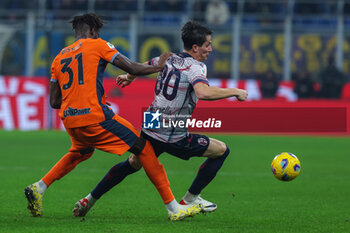 2023-12-20 - Giovanni Fabbian of Bologna FC competes for the ball with Yann Aurel Ludger Bissek of FC Internazionale during Coppa Italia 2023/24 Round of 16 football match between FC Internazionale and Bologna FC at Giuseppe Meazza Stadium, Milan, Italy on December 20, 2023 - INTER - FC INTERNAZIONALE VS BOLOGNA FC - ITALIAN CUP - SOCCER