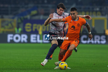 2023-12-20 - Lautaro Martinez of FC Internazionale competes for the ball with Giovanni Fabbian of Bologna FC during Coppa Italia 2023/24 Round of 16 football match between FC Internazionale and Bologna FC at Giuseppe Meazza Stadium, Milan, Italy on December 20, 2023 - INTER - FC INTERNAZIONALE VS BOLOGNA FC - ITALIAN CUP - SOCCER