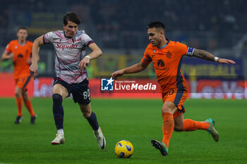 2023-12-20 - Lautaro Martinez of FC Internazionale seen in action with Giovanni Fabbian of Bologna FC during Coppa Italia 2023/24 Round of 16 football match between FC Internazionale and Bologna FC at Giuseppe Meazza Stadium, Milan, Italy on December 20, 2023 - INTER - FC INTERNAZIONALE VS BOLOGNA FC - ITALIAN CUP - SOCCER