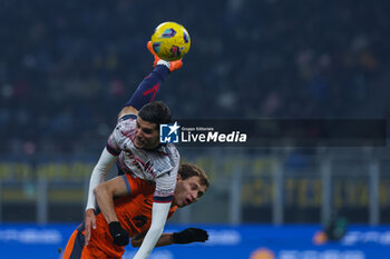 2023-12-20 - Nicolo Barella of FC Internazionale competes for the ball with Oussama El Azzouzi of Bologna FC during Coppa Italia 2023/24 Round of 16 football match between FC Internazionale and Bologna FC at Giuseppe Meazza Stadium, Milan, Italy on December 20, 2023 - INTER - FC INTERNAZIONALE VS BOLOGNA FC - ITALIAN CUP - SOCCER