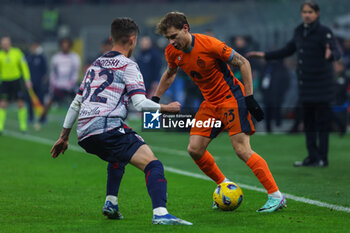 2023-12-20 - Nicolo Barella of FC Internazionale competes for the ball with Kacper Urbanski of Bologna FC during Coppa Italia 2023/24 Round of 16 football match between FC Internazionale and Bologna FC at Giuseppe Meazza Stadium, Milan, Italy on December 20, 2023 - INTER - FC INTERNAZIONALE VS BOLOGNA FC - ITALIAN CUP - SOCCER